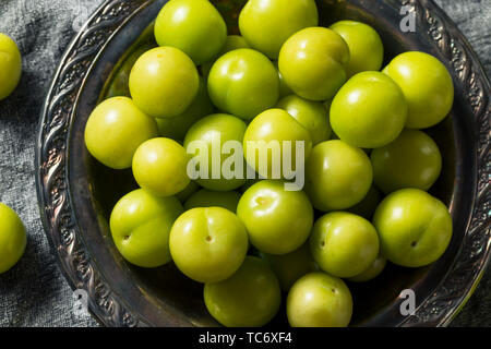 Raw Green Organic Sour Plums in a Bowl Stock Photo