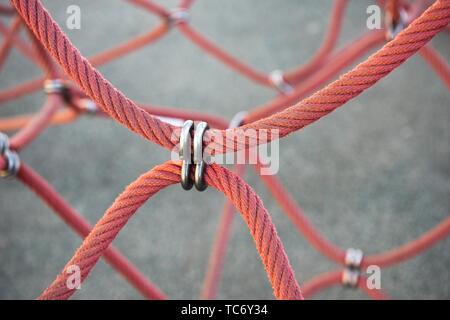 Red ship ropes connected by reef knot Stock Photo