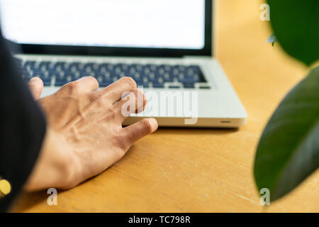 Closeup photo of Man's hands typing on laptop keyboard Stock Photo