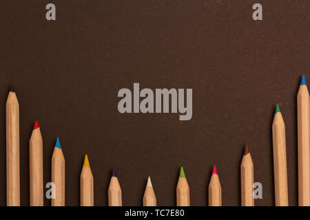 Color pencils lie on a black background Stock Photo
