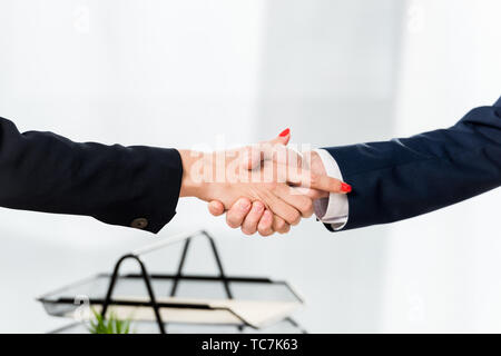 cropped view of recruiter shaking hands with employee in office Stock Photo