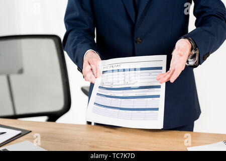 cropped view of recruiter holding - Cropped View Of Recruiter Holding Resume While Gesturing In Office Tc7k7d 