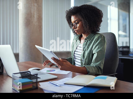 Female businesswoman analyzing the business report in the office Stock Photo