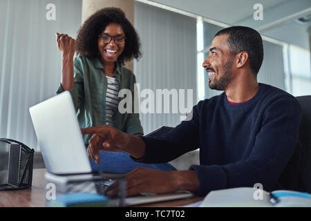 Cheerful young businesswoman celebrating their success Stock Photo
