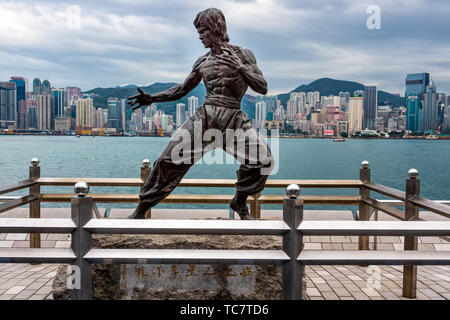 Hong Kong, China, March 2013 Famous Bruce Lee statue at the Avenue of Stars in Tsim Sha Tsui with city skyline in background Stock Photo