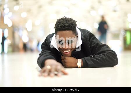 happy young man laying on the ground in public, in city Munich, Germany  Stock Photo - Alamy