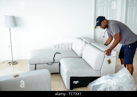 Miami Beach Florida,North Beach,West Elm furniture delivery,Black man men male,unpacking,assembling putting together sofa,FL190430063 Stock Photo
