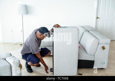 Miami Beach Florida,North Beach,West Elm furniture delivery,Black man men male,unpacking,assembling putting together sofa,FL190430064 Stock Photo