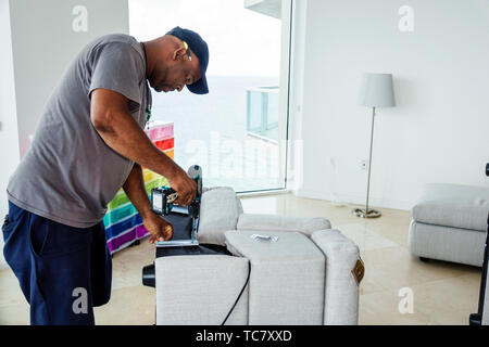Miami Beach Florida,North Beach,West Elm furniture delivery,Black man men male,unpacking,assembling putting together sofa,FL190430065 Stock Photo