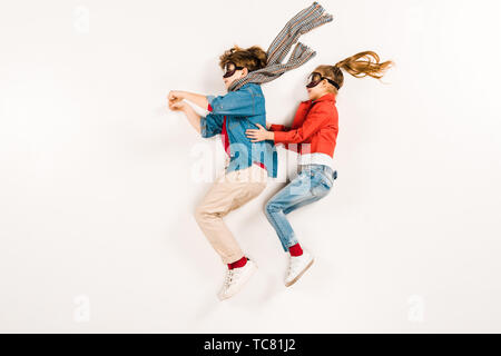 top view of happy kids in super hero masks gesturing on white Stock Photo