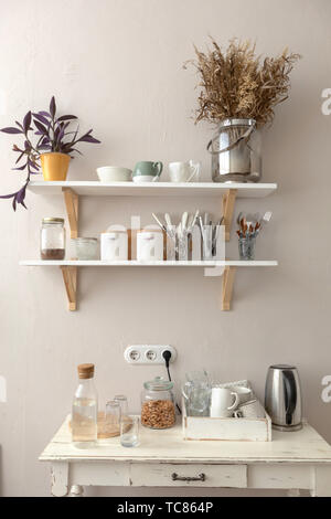 Pots with various houseplants and assorted dishware Stock Photo
