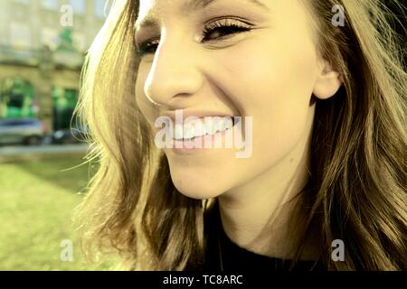 happy woman with toothy smile, in Munich, Germany.