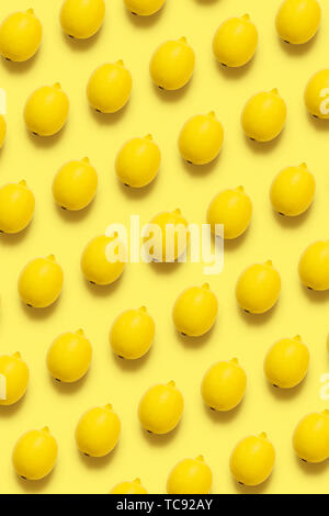 Lemon pattern on pastel yellow background. Minimal summer concept Flat lay Vertical. Stock Photo