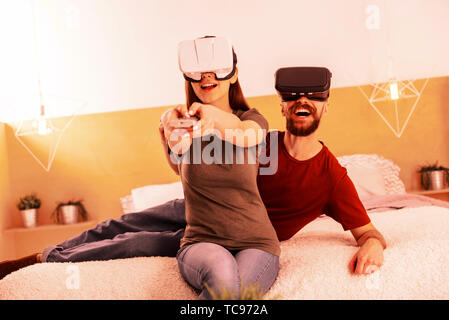 Nice couple playing different virtul games while being at home Stock Photo