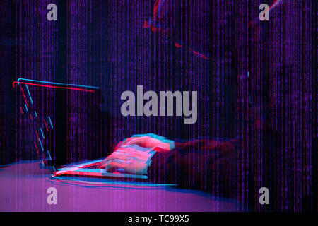 Hacker working with laptop in dark room with digital interface around. Image with glitch effect. Stock Photo