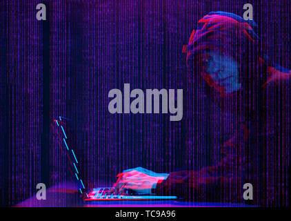 Hacker working with laptop in dark room with digital interface around. Image with glitch effect. Stock Photo