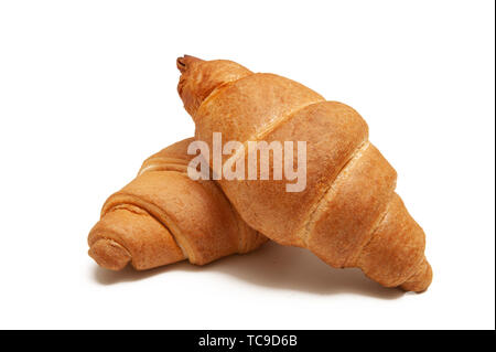 two baked croissants on a white background. Stock Photo