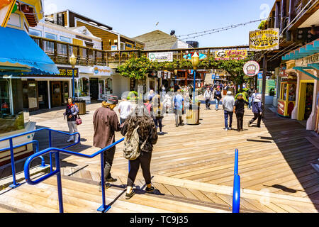 June 3, 2019 San Francisco / CA / USA -  Visitors walk on Pier 39, a shopping center and popular tourist attraction built on a pier in Fisherman's Wha Stock Photo