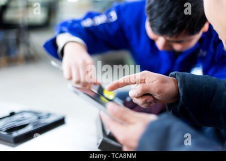 young technicians checking product in manufacturing factory Stock Photo