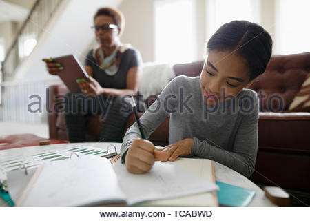 Girl doing homework in living room
