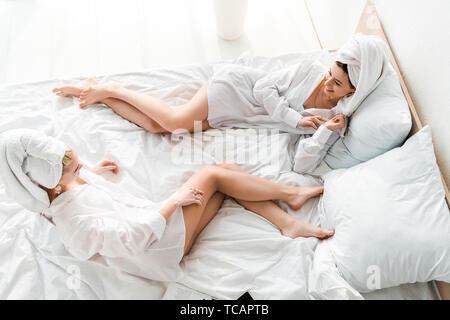 Girls in white towels relaxing in the sauna Stock Photo - Alamy