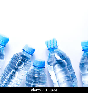 Several drinking water bottles on white background. Eco concept. Copy space for your text. Stock Photo