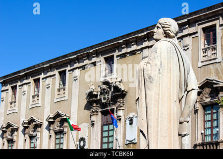 Catania, Italy - Apr 10th 2019: Beautiful detail of Antique statue on Baroque Catania Cathedral with blurred Town Hall building in the background. The beautiful city is a popular tourist attraction. Stock Photo