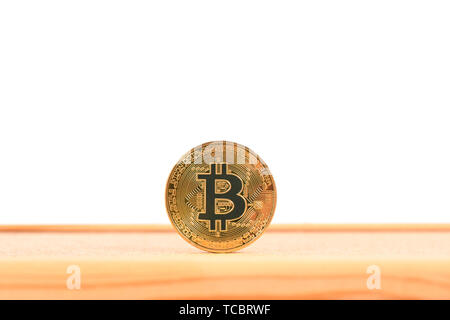 Golden bitcoin on brown textured cork. High resolution photo. Full depth of field. Stock Photo