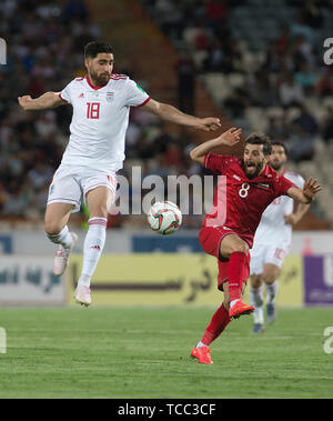 Tehran, Iran. 6th June, 2019. Alireza Jahanbakhsh (L) of Iran vies with Mohmoud Al Mawas of Syria during a friendly football match at Azadi Stadium in Tehran, Iran, June 6, 2019. Iran won 5-0. Credit: Ahmad Halabisaz/Xinhua/Alamy Live News Stock Photo