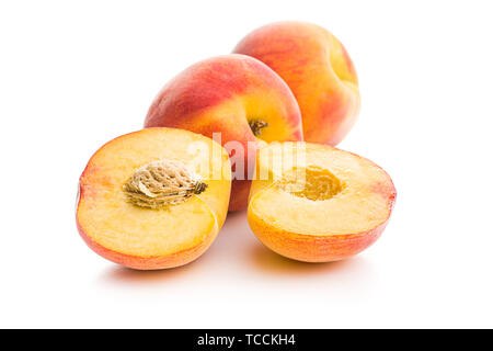 Halved sweet peaches fruit isolated on white background. Stock Photo