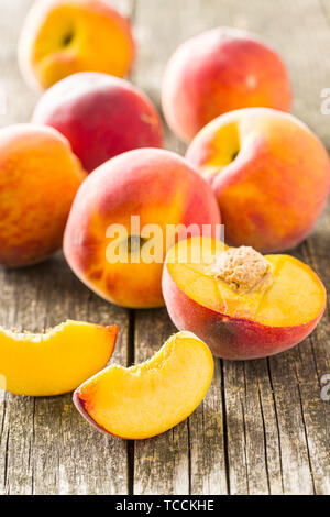 Sweet peaches fruit on old wooden table. Stock Photo