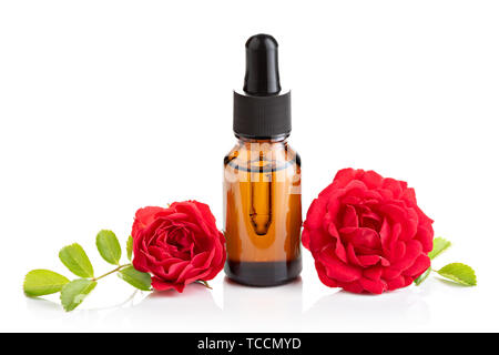 Rose essential oil in glass bottle with dropper on white background Stock Photo