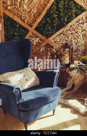 Blue arm-chair with knitted beige pillow,modern interior Stock Photo