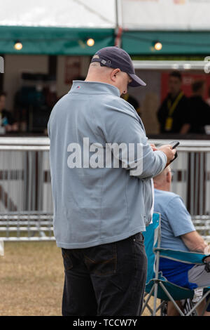 A man using a mobile phone or a cell phone Stock Photo