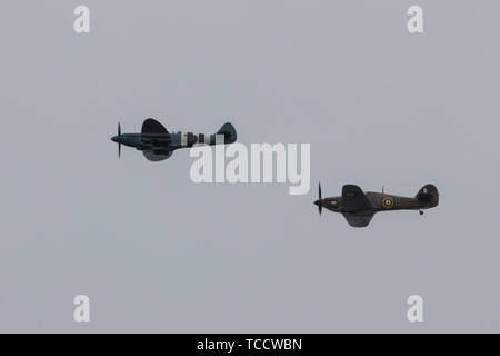 two world war two planes in flight spitfire plane and a hurricane plane in formation Stock Photo