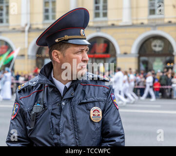 Policeman controlling crowd at St Petersburg City Day Parade, Nevsky Prospekt, St Petersburg, Russia Stock Photo