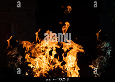 Wood fire on black background.Flames of fire on black background. Fire rages in the dark. Bonfire at night. Flames are dancing.Orange flame background