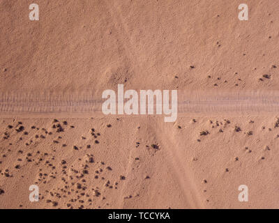 Aerial view of a desert landscape on the island of Lanzarote, Canary Islands, Spain. Road that crosses a desert. Dirt road. Desert soil, sand, rock Stock Photo