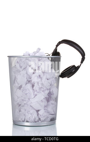 headphones and paper in metal trash bin isolated on white Stock Photo