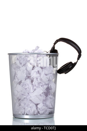 headphones and paper in metal trash bin isolated on white Stock Photo