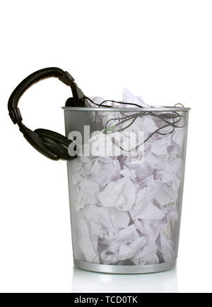 headphones and paper in metal trash bin isolated on white Stock Photo