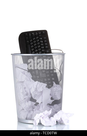 Old PC keyboard and paper in metal trash bin isolated on white Stock Photo