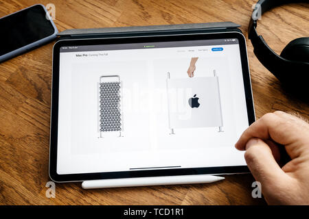 Paris, France - Jun 6, 2019: Man reading on Apple iPad Pro tablet about latest announcement of at Apple Worldwide Developers Conference WWDC - showing the new Mac Pro workstation and top handle Stock Photo