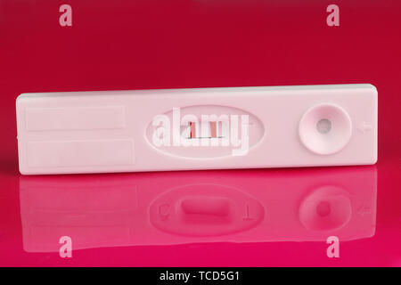 positive pregnancy test on pink background Stock Photo