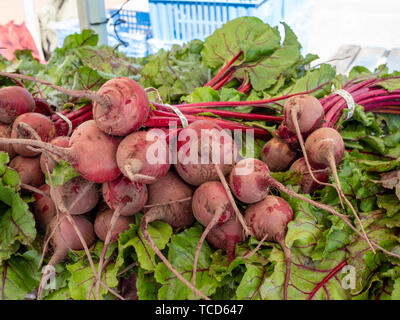 Beets sitting on table on display at an outdoor grocery mart Stock Photo