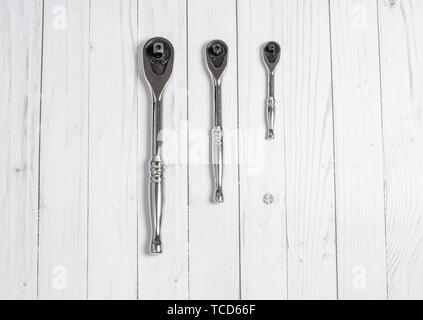 Tools, socket wrenches on a white wooden background. Top view Stock Photo