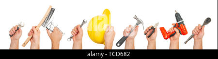 Hand tools. Hands holding construction tools isolated on white background. Stock Photo