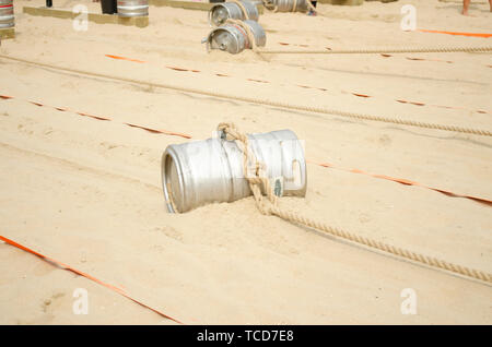 Sports competition with a barrel and a rope on the beach Stock Photo ...