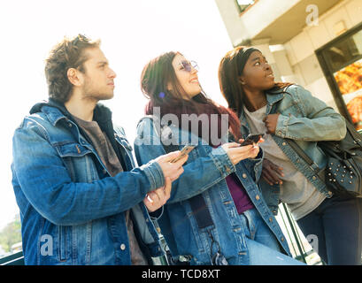 Multiracial friends taking selfie outdoors. Happy friendship concept with young students having fun together Stock Photo