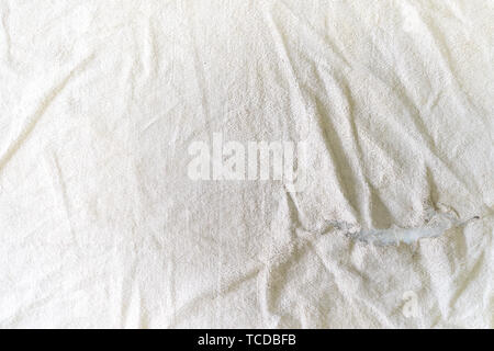 teared rag spread out to flat on the floor, can use like a background or any texture. Stock Photo